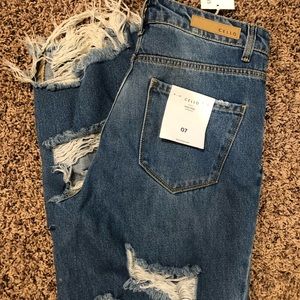 Distressed boutique denim jeans